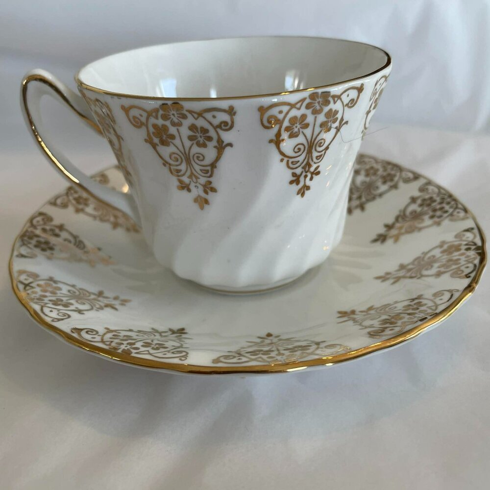 SUTHERLAND and DELPHINE CASTLECORE  tea cup and saucer set, England. Vintage.